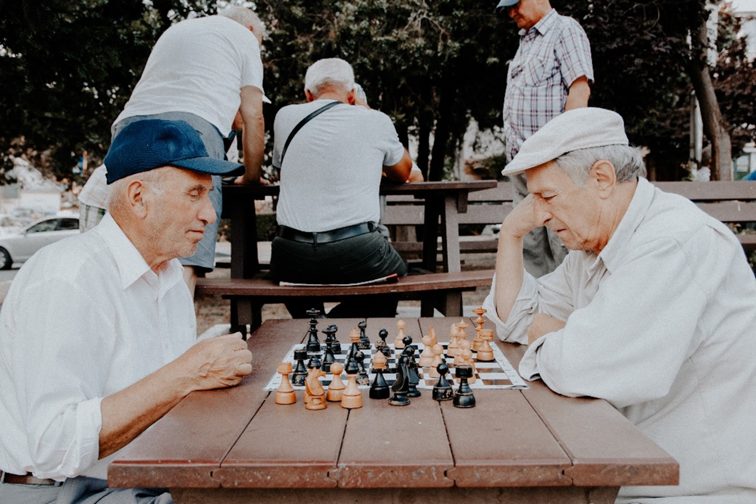 Seniors playing chess outdoors